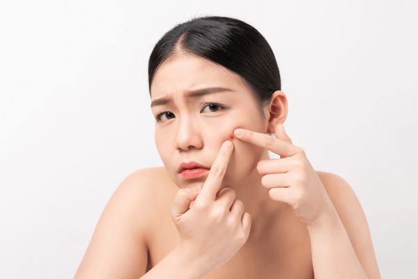 asian woman squeezing pimples on 600nw 1694812936